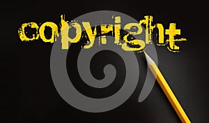 Copyright word in yelow on black and pencil besides. Trademark Identity Owner Legal Concept