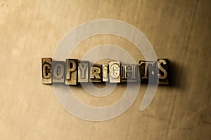 COPYRIGHTS - close-up of grungy vintage typeset word on metal backdrop photo