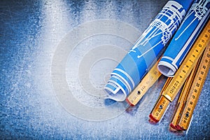 Copyspace of blue engineering drawings wooden meter on metallic photo