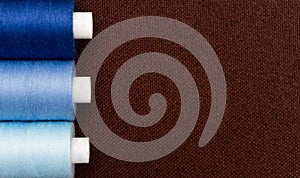 Copyspace on brown fabric with thread bobbins