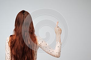 Copyspace with caucasian woman with long red hair from the back