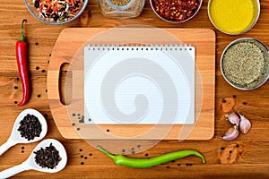 Copyspace food frame with notepad paper spices and cooking accesories