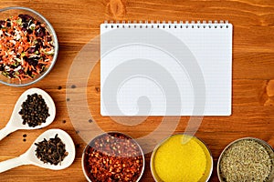 Copyspace food frame with notepad paper spices and cooking accesories