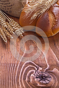 Copyspace image bread and wheat ears on old wooden