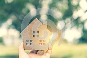 Copyspace model of a little house that woman holds it background