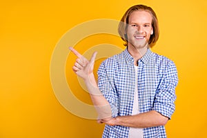 Copyspace photo of handsome student pointing at empty space away with his forefinger standing confidently isolated over