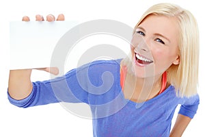 Copyspace for your awesome product. A beautiful young woman holding a blank card while isolated on a white background.