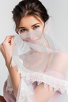 coquettish fiancee covering face with veil