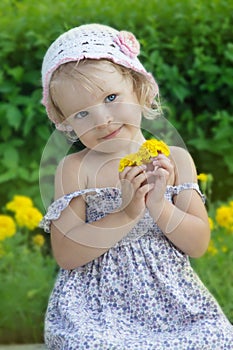 Coquettish little girl portrait with flowers