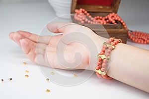 Coral beaded bracelet on woman wrist photo