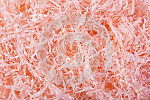 Coral color shredded paper - gift box filler background.