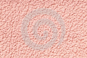 Coral fluffy background of soft, fleecy cloth. Texture of textile closeup.