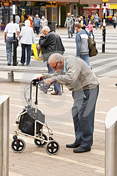 Corby, United Kingdom - august 28, 2018: An Old man using mobility aid standing walking basing on walker conceptual togetherness h