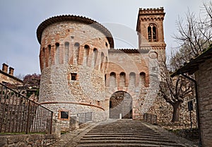 Corciano, Perugia, Umbria, Italy: the city gate Porta di Santa Maria with the round tower and the bell tower of the church photo