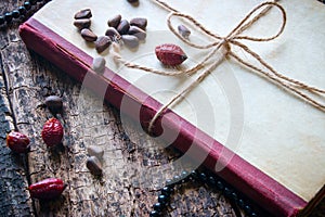 Corded book with beads, dogrose, nuts