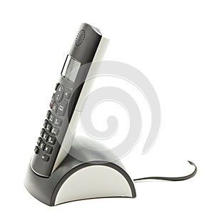 Cordless phone in cradle on white background.