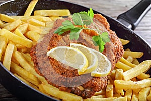 Cordon Bleu with French fries and lemon slices
