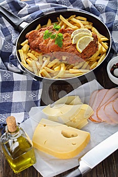 Cordon Bleu on skillet with French fries