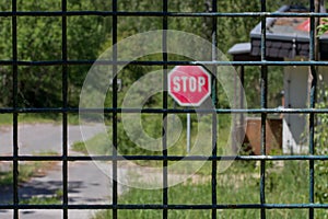 Cordoned off path in the forest with a stop sign photo