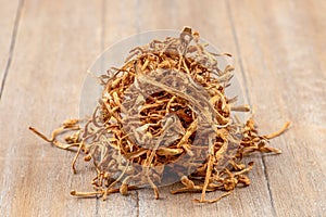 Cordyceps militaris mushroom on an old wooden background