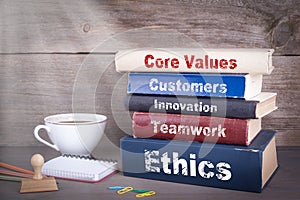 Core Values concept. Stack of books on wooden desk