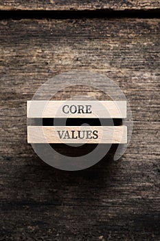 Core values sign written on two stacked wooden pegs