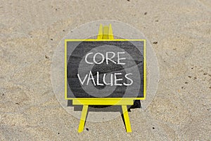 Core values symbol. Concept words Core values on black chalk blackboard on a beautiful sand beach background. Business value and