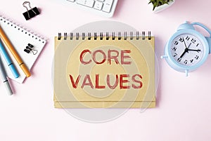 Core Values - text inside notebook on table