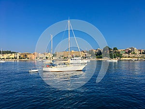 Corfu, Greece - July 7, 2018: Beautiful view of the city of Kerkyra and sailing yachts in the Greek bay against the blue sky