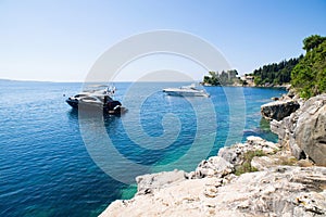 Corfu island, Greece, beautiful bay with a boat. Picturesque greek seascape. Yachting and travel concept