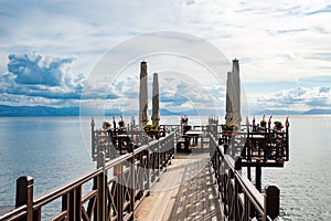 Corfu Island, Greece - October 4, 2019: Wooden pier with cafe in Ionian sea. Greece