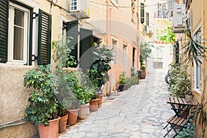 Corfu town beautiful street with cafe and flowers, Corfu island, Ionian islands, Greece. Picturesque landmark of Kerkyra old town.