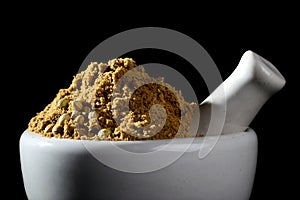 Coriander Powder and Coriander seeds on black background