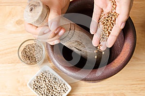 Coriander seed pounding in mortar