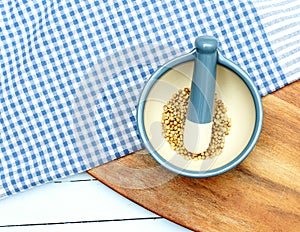 Coriander seeds in pestle and mortar