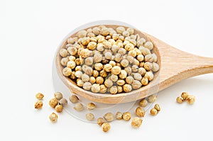 Coriander seeds in a wooden spoon