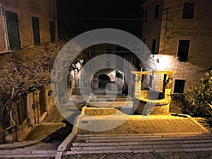 Corinaldo town in the province of Ancona, Marche region, Italy. History, time, stairway and water well photo