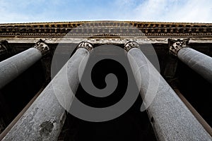 Corinthian columns from the portico of the Pantheon, Rome, Italy, also known as Santa Maria Rotonda. View from below, under a blue