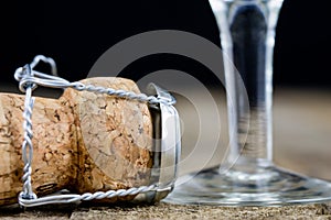 Cork from champagne on a wooden kitchen table. Good New Year's d