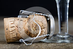 Cork from champagne on a wooden kitchen table. Good New Year& x27;s d