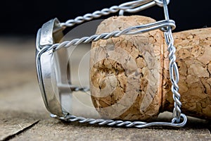 Cork from champagne on a wooden kitchen table. Good New Year's d