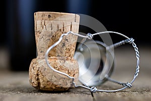 Cork from champagne on a wooden kitchen table. Good New Year& x27;s d