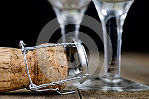 Cork from champagne on a wooden kitchen table. Good New Year's d