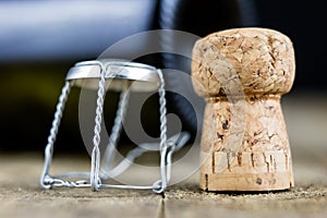 Cork from champagne on a wooden kitchen table. Good New Year& x27;s d
