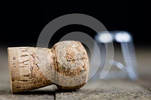 Cork from champagne on a wooden kitchen table. Good New Year's d