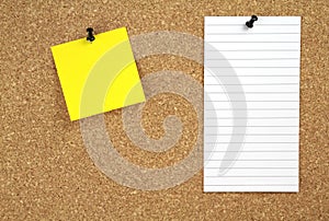 Cork notice board with yellow and white note paper