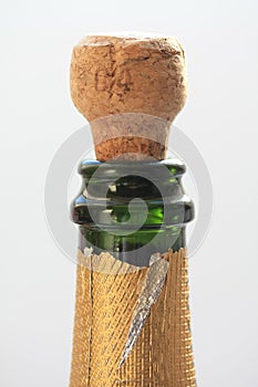 cork popping out of champagne bottle