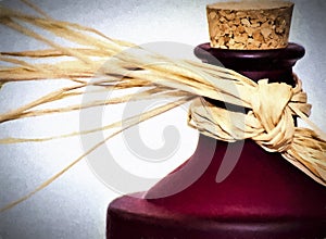 Corked Red Wine Bottle With Straw Ribbon Around Neck