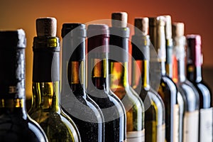 Corked and uncorked wine bottles in line closeup. Wine background photo