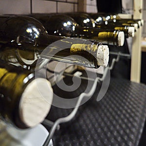 Corked wine bottles lying on a shelf, narrow depth of field